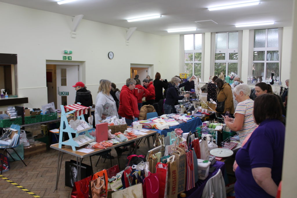 The village hall set up with tables for a craft sales event
